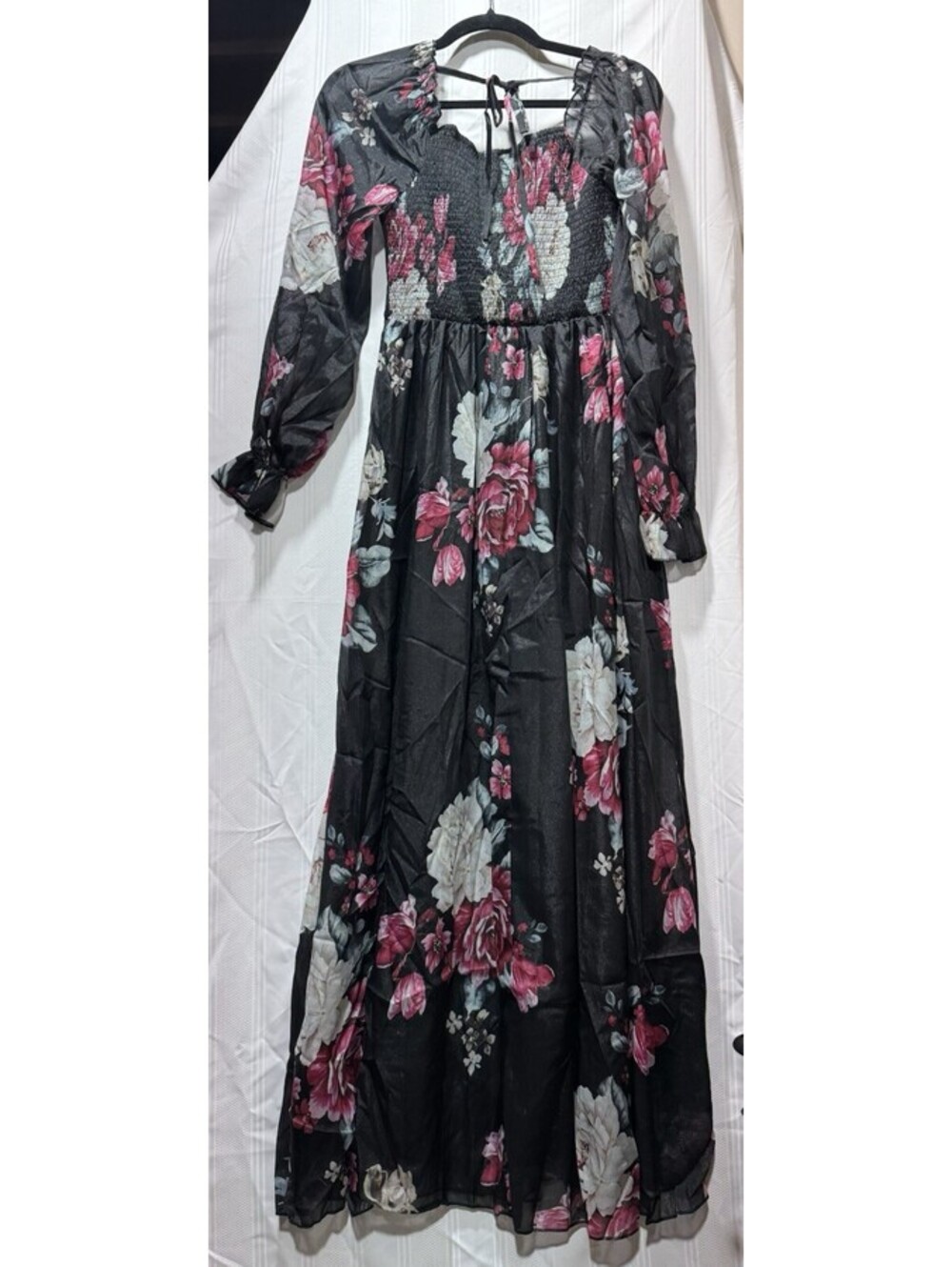long black floral maxi dress featuring a smocked bodice